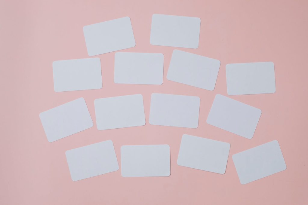 set of empty white papers attached on pink wall